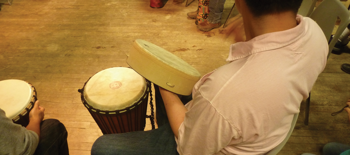 young man in a drum circle
