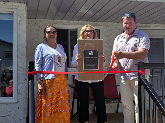 Ribbon cutting with elder, Greg, Natalie